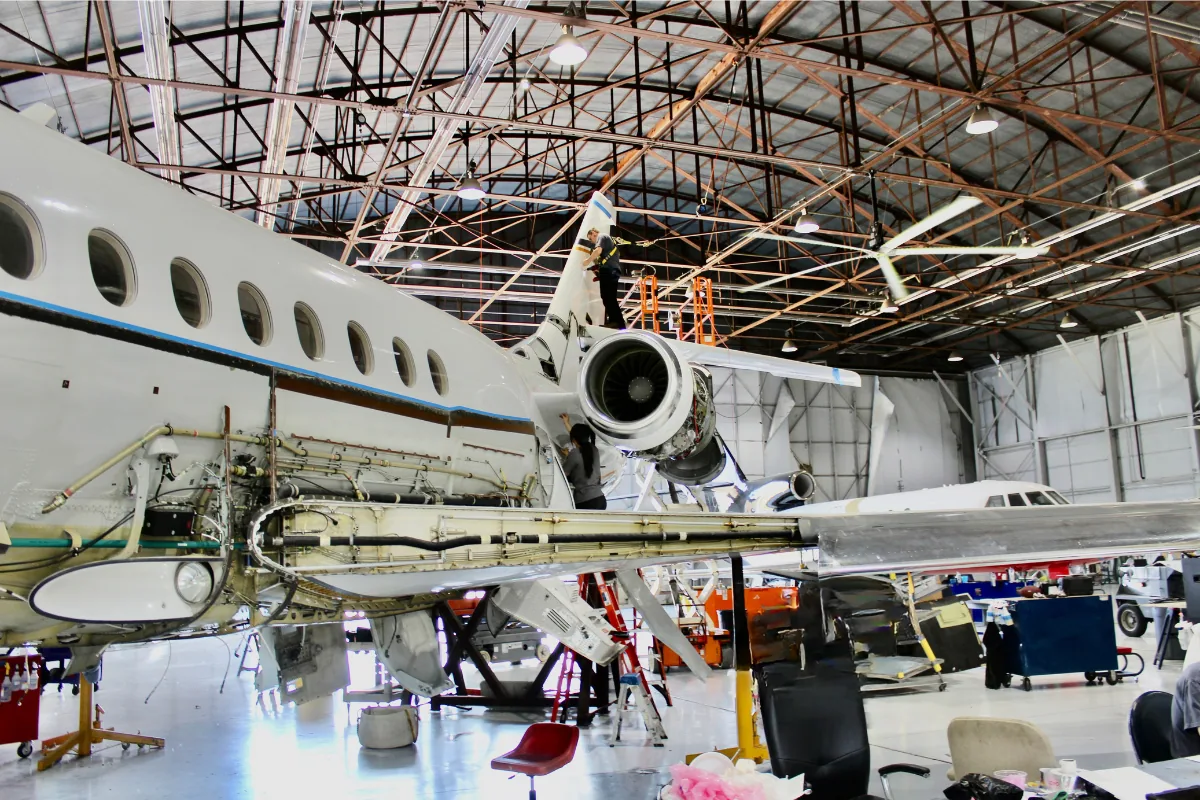 Aircraft undergoing restoration and maintenance inside a hangar